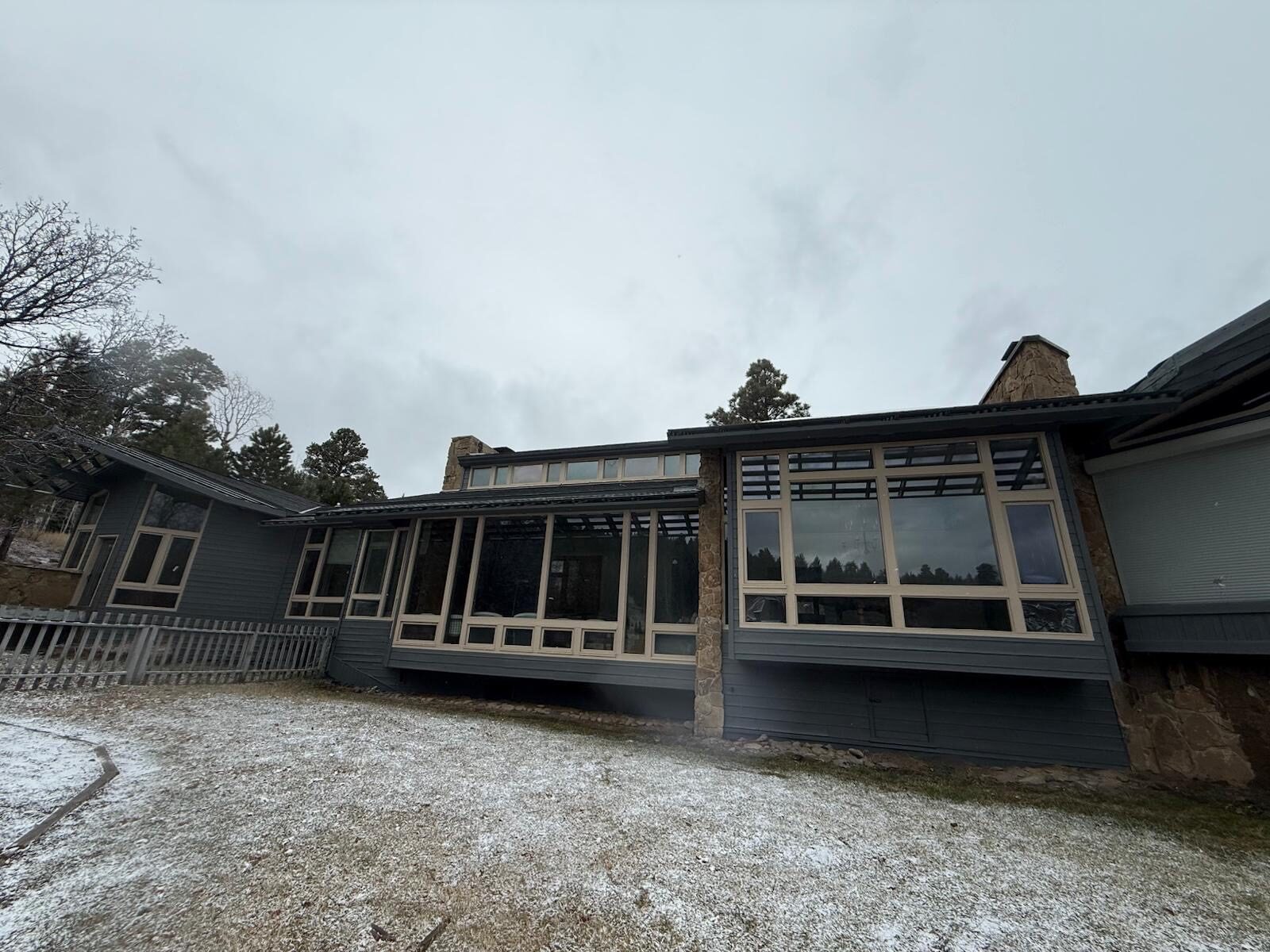 Completed mountain home exterior with expansive windows